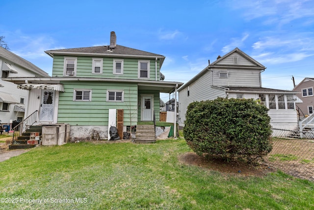 37 Goeringer Ave, Hanover Twp, PA 18706 - rear view of property featuring a lawn, fence, and a chimney