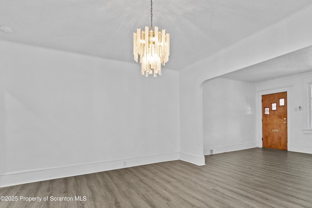 37 Goeringer Ave, Hanover Twp, PA 18706 - unfurnished dining area with arched walkways, baseboards, wood finished floors, and a chandelier