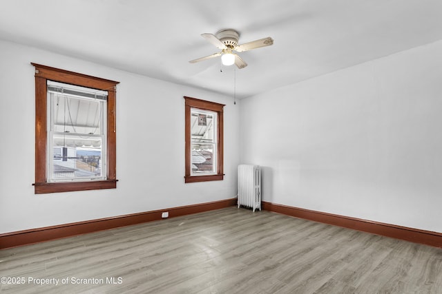 37 Goeringer Ave, Hanover Twp, PA 18706 - empty room featuring baseboards, a healthy amount of sunlight, radiator, and light wood-type flooring
