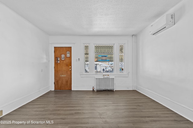 37 Goeringer Ave, Hanover Twp, PA 18706 - entryway featuring wood finished floors, baseboards, a wall mounted air conditioner, radiator heating unit, and a textured ceiling
