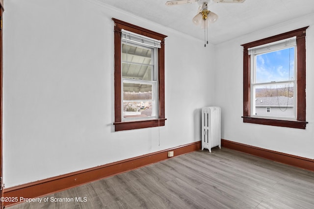 37 Goeringer Ave, Hanover Twp, PA 18706 - unfurnished room with a ceiling fan, wood finished floors, baseboards, radiator heating unit, and ornamental molding