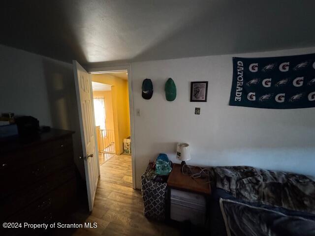 bedroom with hardwood / wood-style flooring