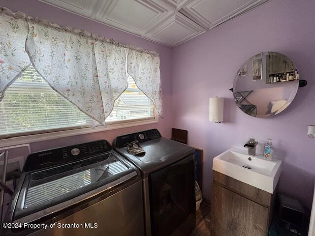 washroom with washer and dryer and sink