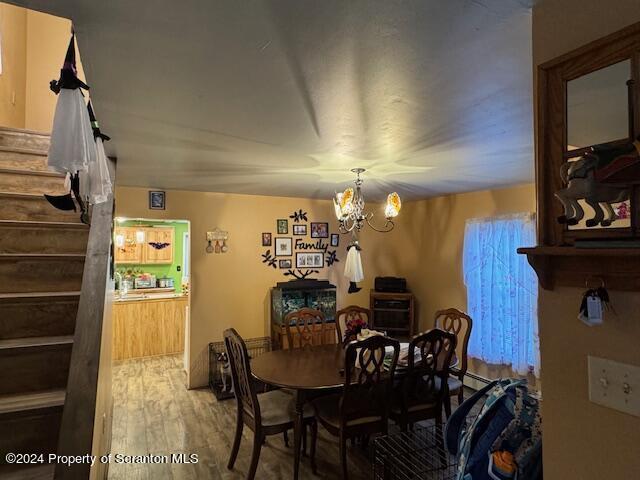 dining space featuring a chandelier and hardwood / wood-style flooring