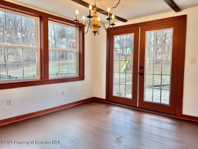 doorway featuring beamed ceiling, hardwood / wood-style flooring, a wealth of natural light, and french doors