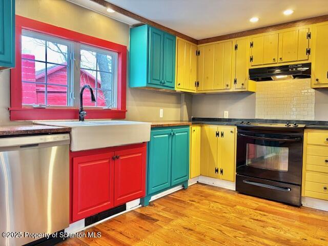 kitchen with black stove, dishwasher, sink, exhaust hood, and light hardwood / wood-style floors