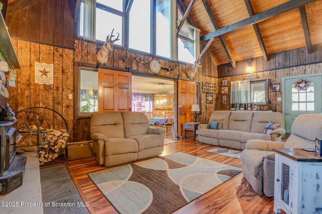 125 Frances Ln, Greentown, PA 18426 - living room with wood finished floors, beam ceiling, wood walls, and high vaulted ceiling