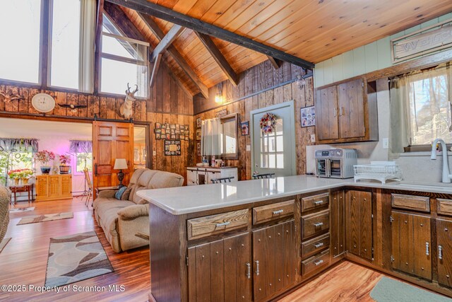 125 Frances Ln, Greentown, PA 18426 - kitchen featuring high vaulted ceiling, a peninsula, light wood-style floors, and wooden walls