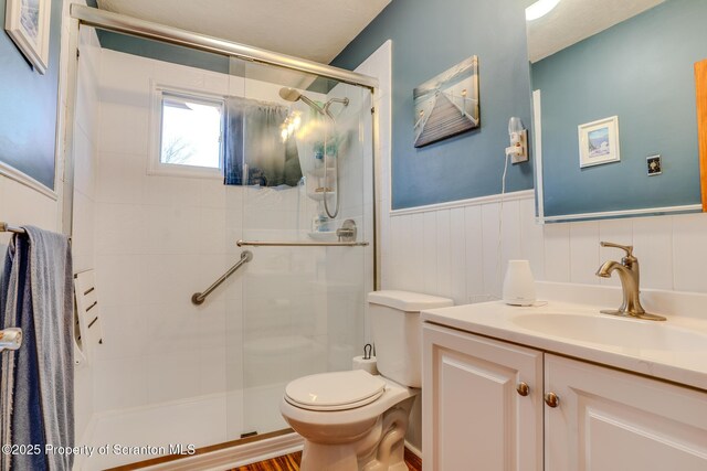 125 Frances Ln, Greentown, PA 18426 - bathroom featuring a shower stall, toilet, vanity, and wainscoting