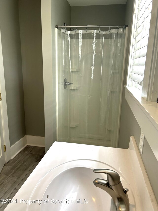 bathroom with a shower with curtain and sink