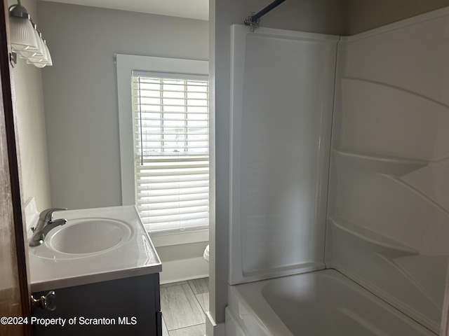 full bathroom featuring plenty of natural light, vanity,  shower combination, and toilet