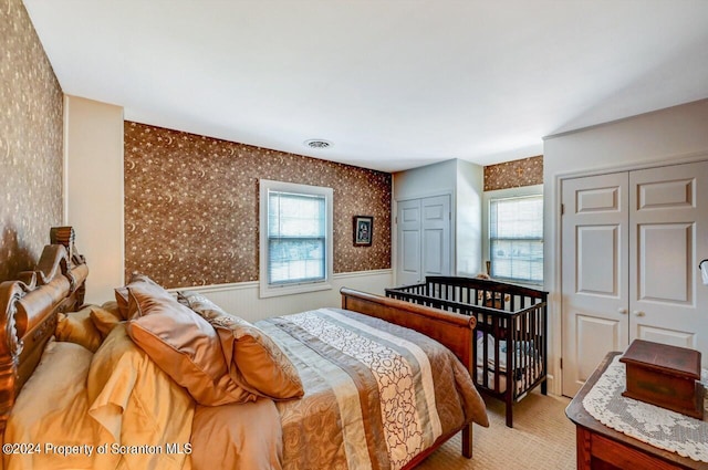 carpeted bedroom with two closets