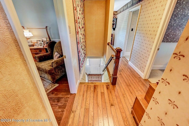 hall with hardwood / wood-style flooring