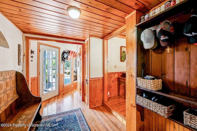 mudroom with french doors, crown molding, wooden walls, light wood-type flooring, and wood ceiling