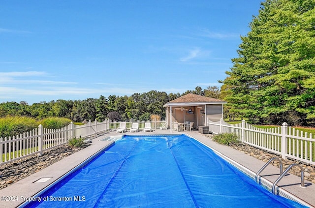 view of swimming pool with an outdoor structure