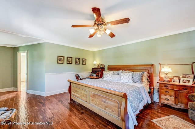 bedroom with dark wood-type flooring, ceiling fan, and ornamental molding