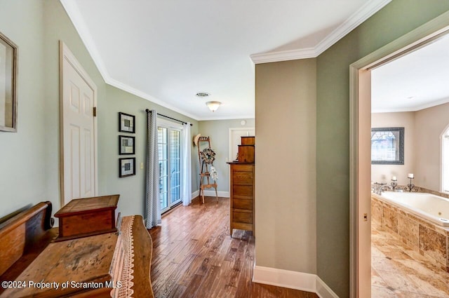 corridor with hardwood / wood-style flooring and ornamental molding