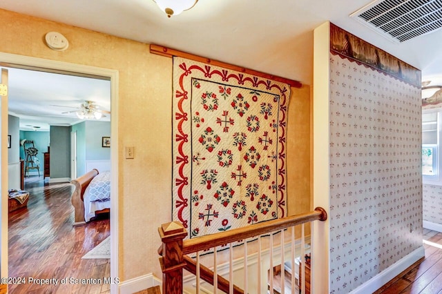 bathroom with ceiling fan and hardwood / wood-style floors