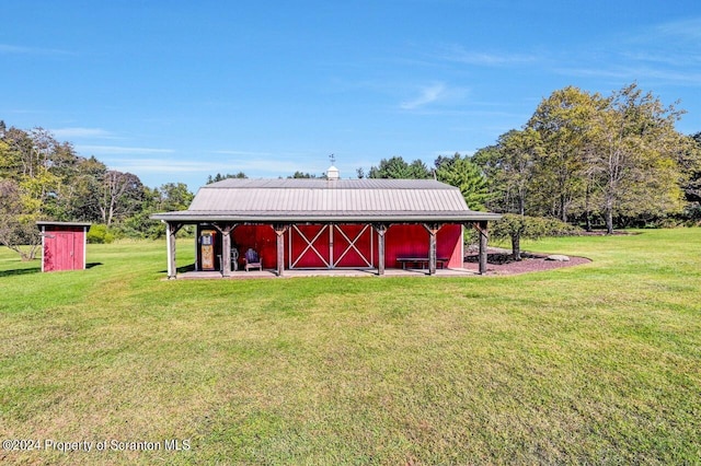 view of outdoor structure featuring a lawn