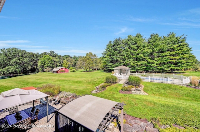 view of yard featuring a gazebo and a pool