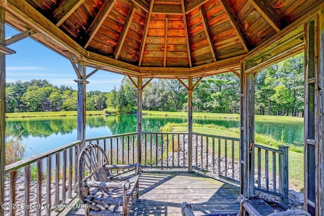 deck with a gazebo and a water view