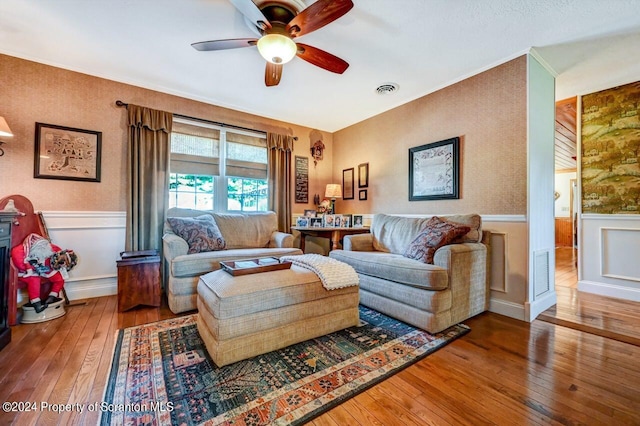 living room with wood-type flooring and ceiling fan