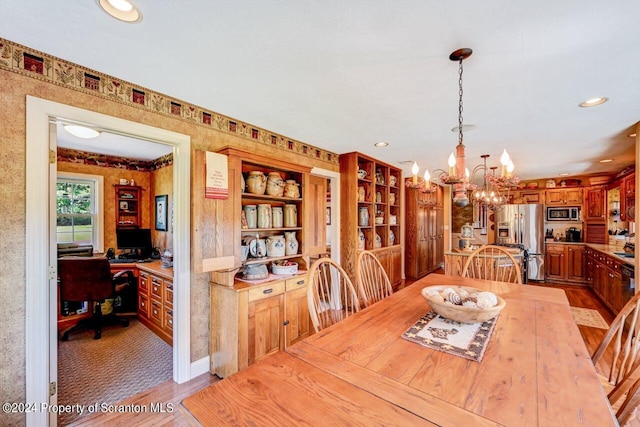 dining room with light hardwood / wood-style floors and a chandelier