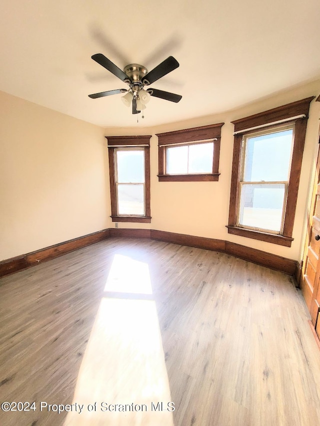 unfurnished room featuring ceiling fan and light hardwood / wood-style floors