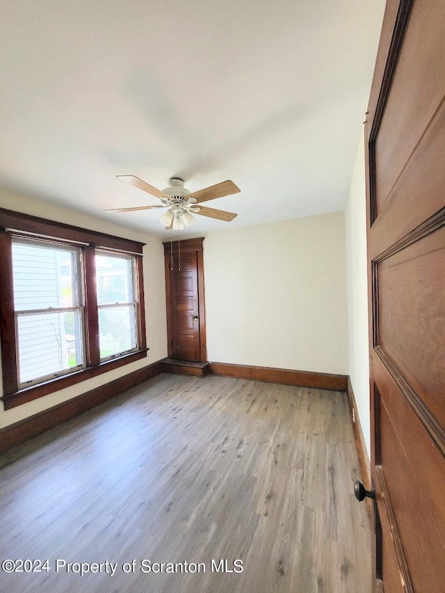 empty room featuring ceiling fan and light wood-type flooring