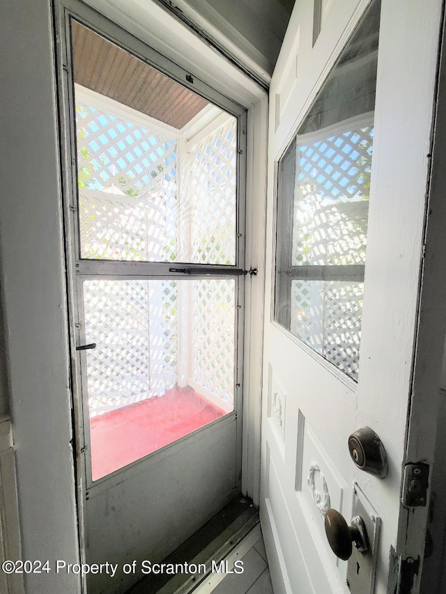 doorway to outside featuring tile patterned floors