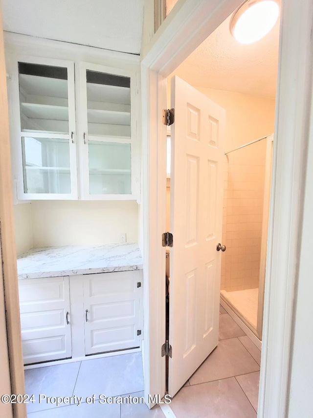 hall featuring light tile patterned floors