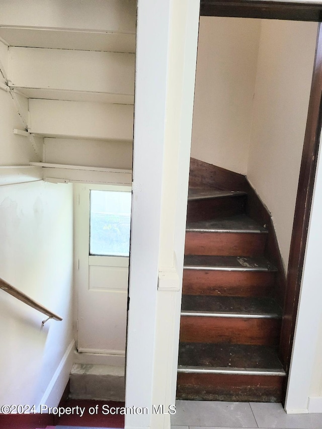 staircase featuring tile patterned floors