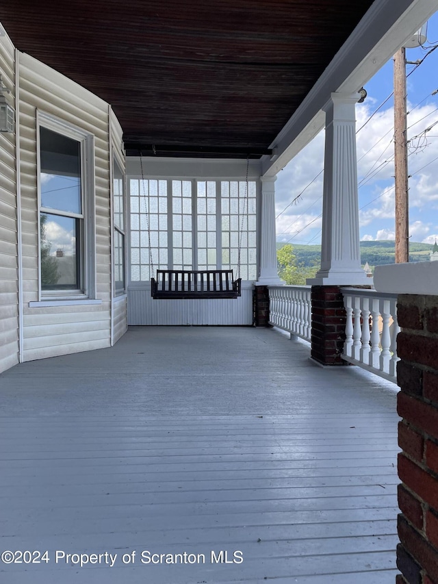 wooden terrace with a porch