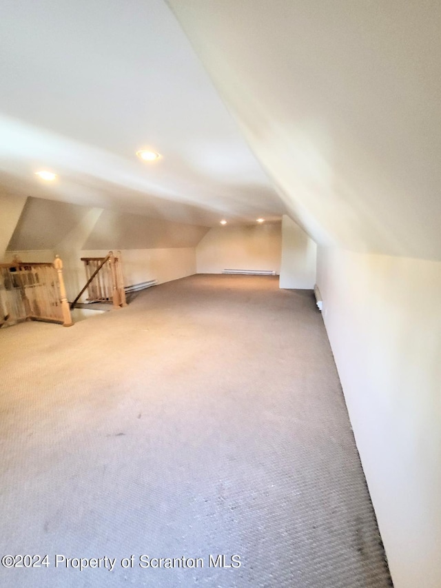 additional living space featuring carpet flooring and lofted ceiling