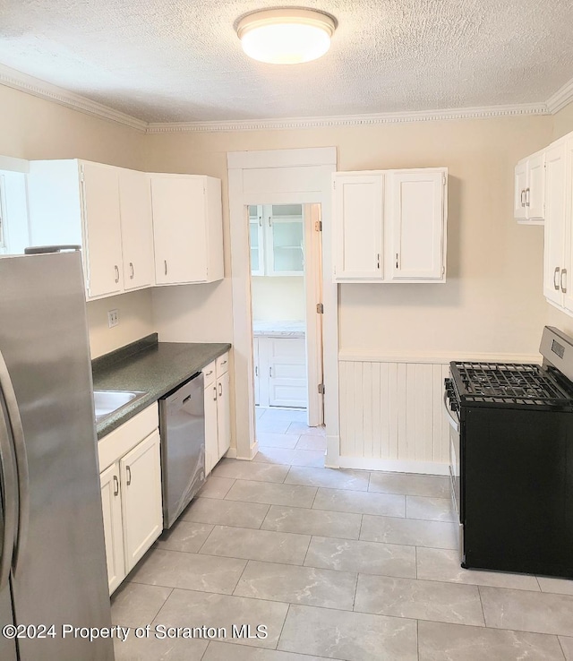 kitchen featuring a textured ceiling, crown molding, white cabinetry, and stainless steel appliances