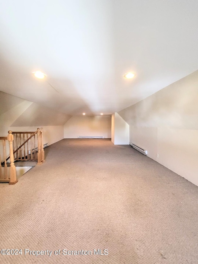 additional living space with carpet flooring, lofted ceiling, and a baseboard radiator