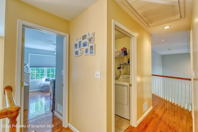 157 Mcesther Dr Unit L 31, Covington Twp, PA 18424 - hall with attic access, light wood finished floors, and independent washer and dryer