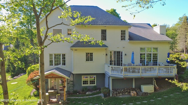 157 Mcesther Dr Unit L 31, Covington Twp, PA 18424 - back of property with a lawn, a wooden deck, a shingled roof, and a chimney