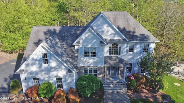 157 Mcesther Dr Unit L 31, Covington Twp, PA 18424 - colonial-style house featuring a porch, stone siding, and a forest view