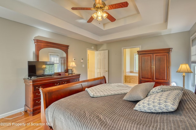 157 Mcesther Dr Unit L 31, Covington Twp, PA 18424 - bedroom with a tray ceiling, light wood-style flooring, and a ceiling fan
