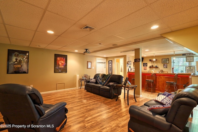 157 Mcesther Dr Unit L 31, Covington Twp, PA 18424 - living area with bar, light wood finished floors, and a paneled ceiling