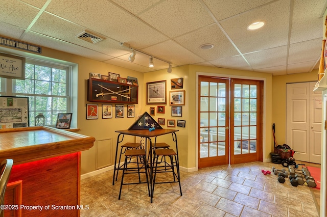 157 Mcesther Dr Unit L 31, Covington Twp, PA 18424 - tiled dining room featuring track lighting, plenty of natural light, and a paneled ceiling