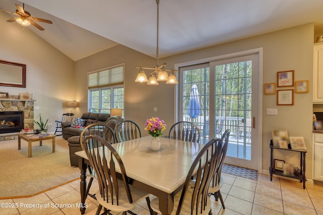 157 Mcesther Dr Unit L 31, Covington Twp, PA 18424 - dining room featuring light tile patterned floors, ceiling fan, a stone fireplace, and lofted ceiling