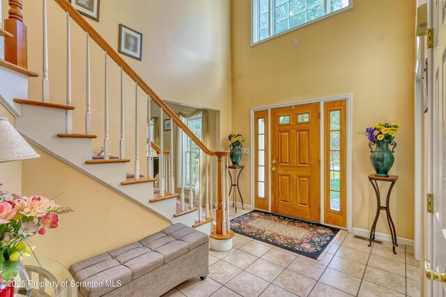 157 Mcesther Dr Unit L 31, Covington Twp, PA 18424 - tiled entrance foyer featuring a towering ceiling and stairs