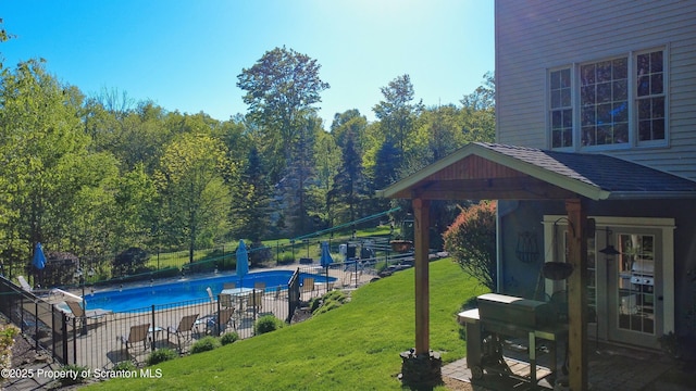 157 Mcesther Dr Unit L 31, Covington Twp, PA 18424 - view of swimming pool featuring a grill and a forest view