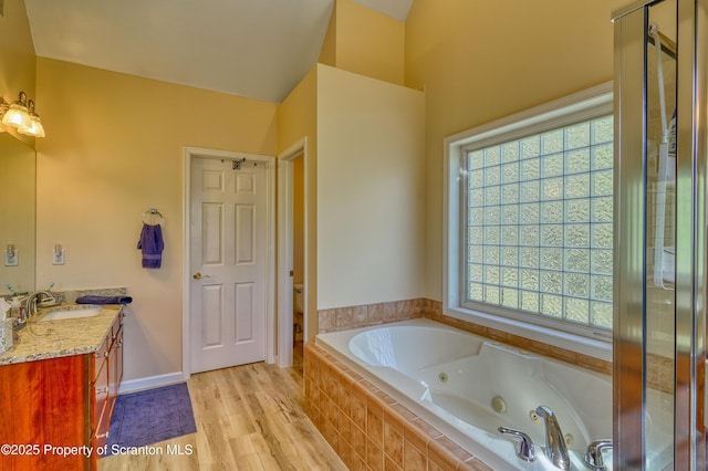 157 Mcesther Dr Unit L 31, Covington Twp, PA 18424 - full bath featuring vanity, a whirlpool tub, wood finished floors, and a shower stall