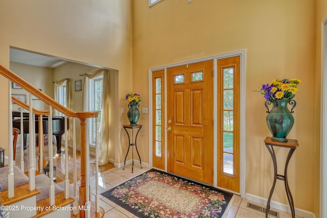 157 Mcesther Dr Unit L 31, Covington Twp, PA 18424 - foyer featuring tile patterned flooring, plenty of natural light, stairs, and a high ceiling