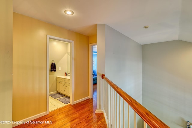 157 Mcesther Dr Unit L 31, Covington Twp, PA 18424 - hall featuring light wood-style flooring, an upstairs landing, recessed lighting, and lofted ceiling