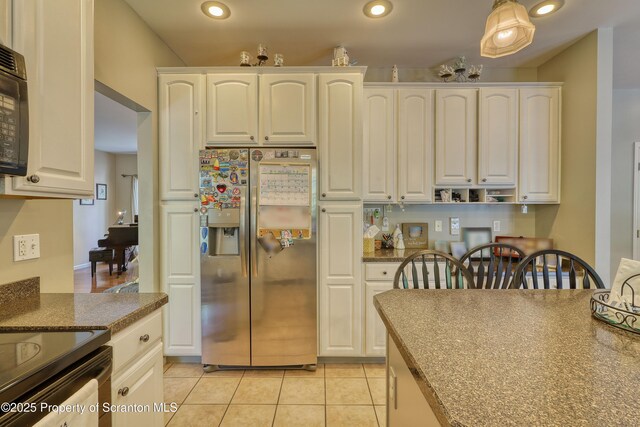 157 Mcesther Dr Unit L 31, Covington Twp, PA 18424 - kitchen with stainless steel fridge, white cabinetry, light tile patterned floors, recessed lighting, and black microwave