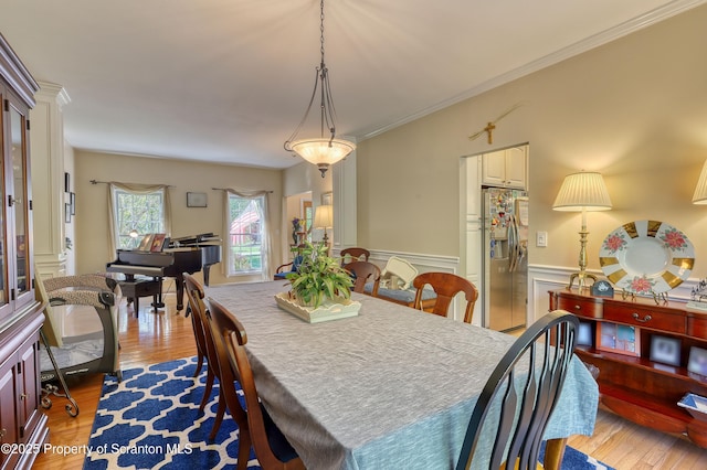 157 Mcesther Dr Unit L 31, Covington Twp, PA 18424 - dining space with light wood finished floors, wainscoting, and ornamental molding